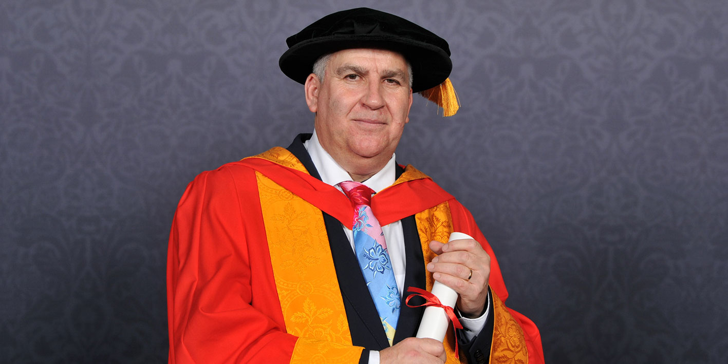 Portrait of Honorary Graduate Lewis Power with his award