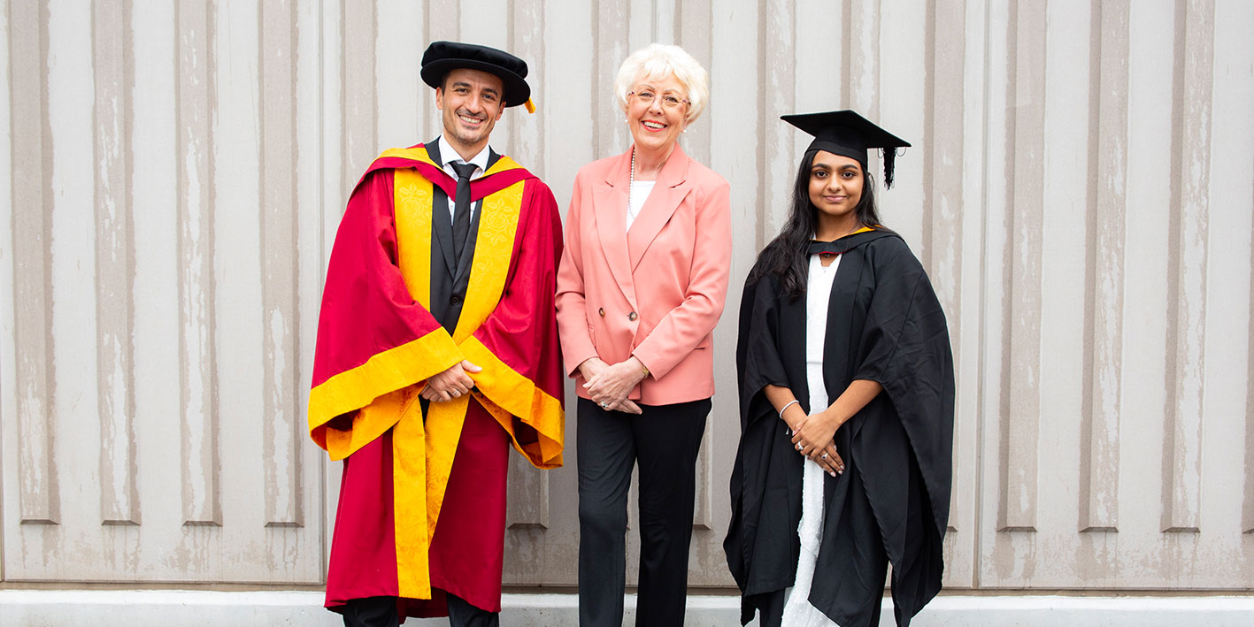 Staff and student with chamber patron