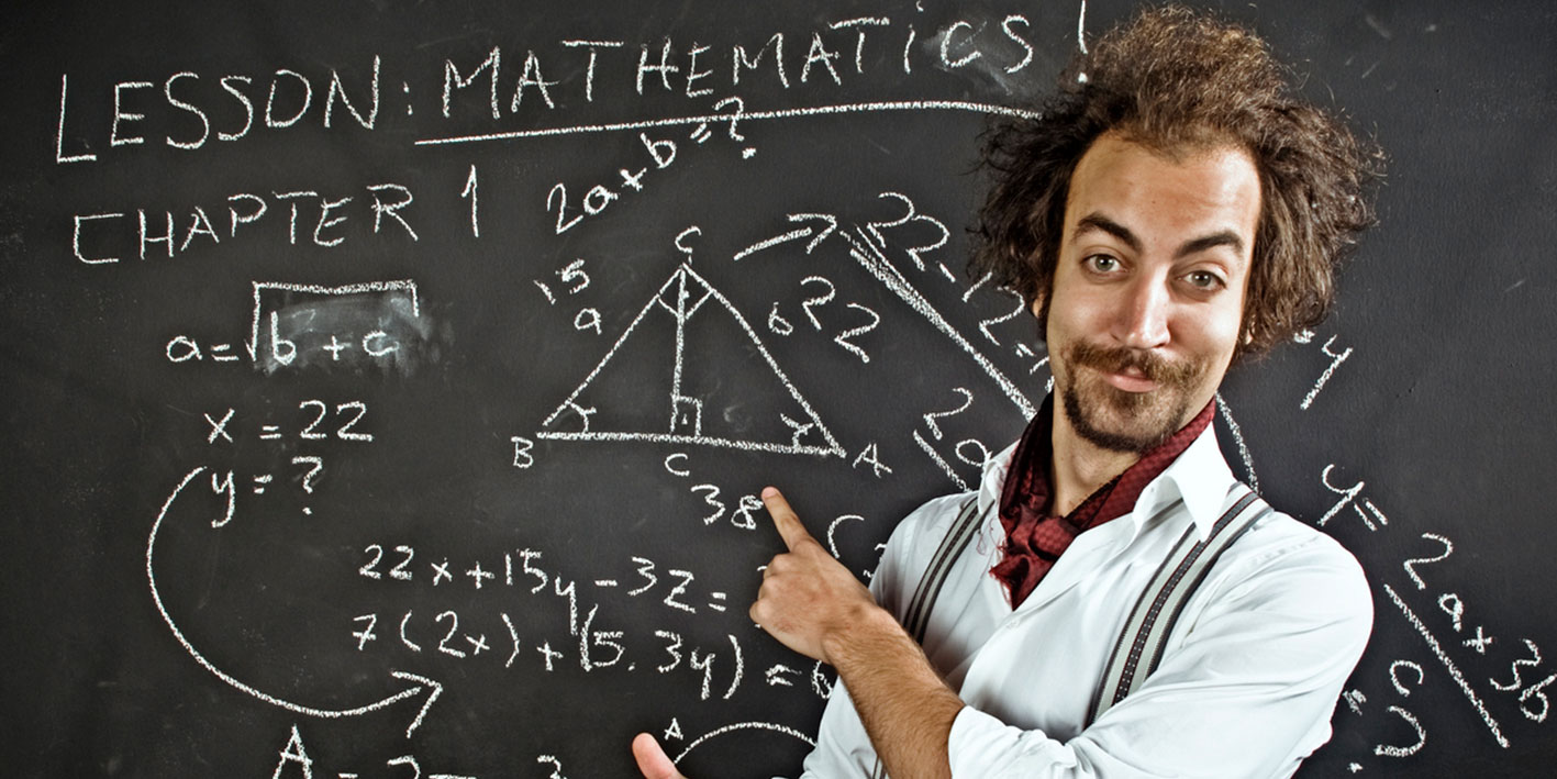An image of a man teaching maths in front of a blackboard