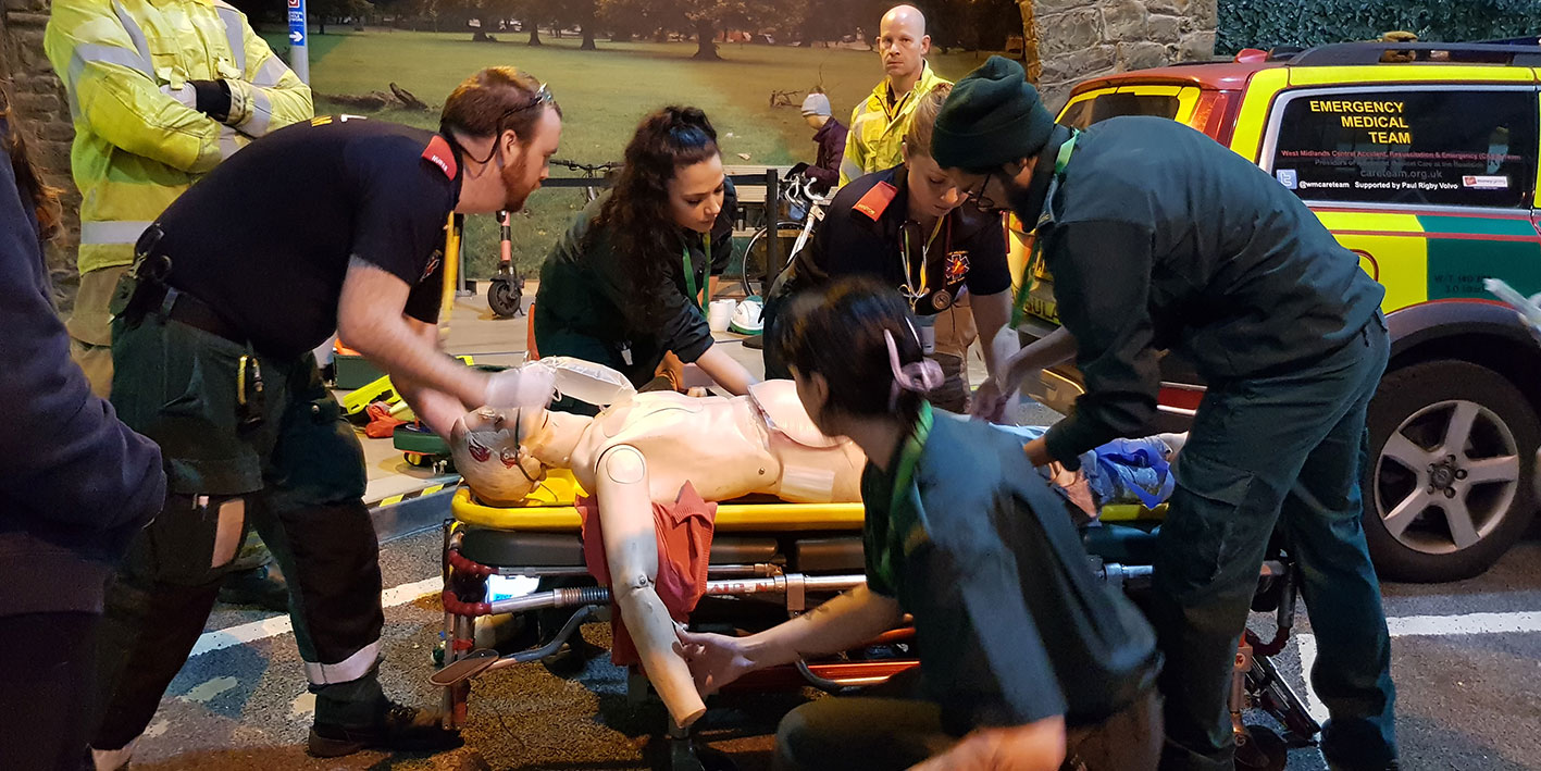Paramedic students working at a simulated critical care exercise