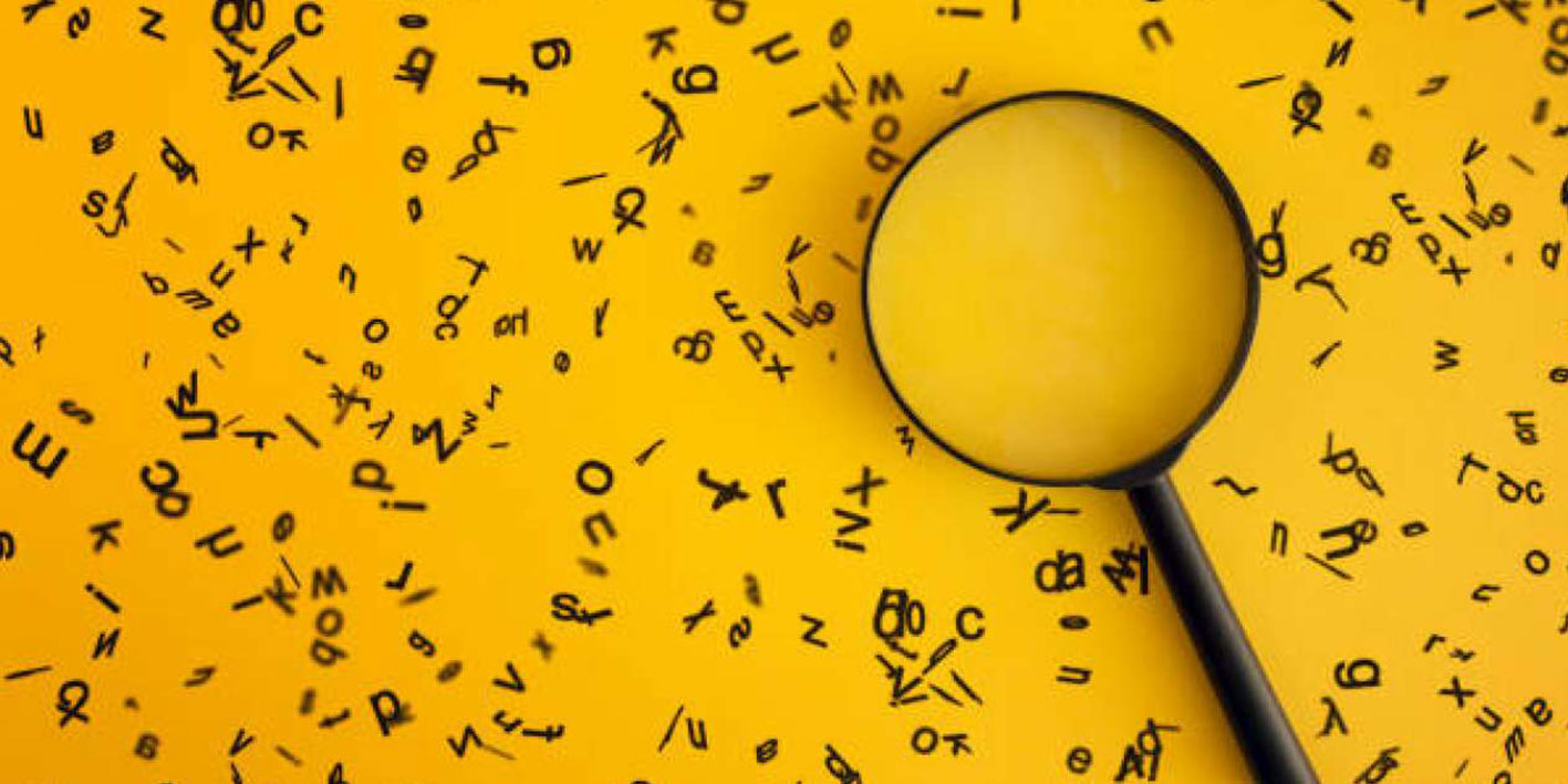 Graphic depicting a magnifying glass against a backdrop of letters