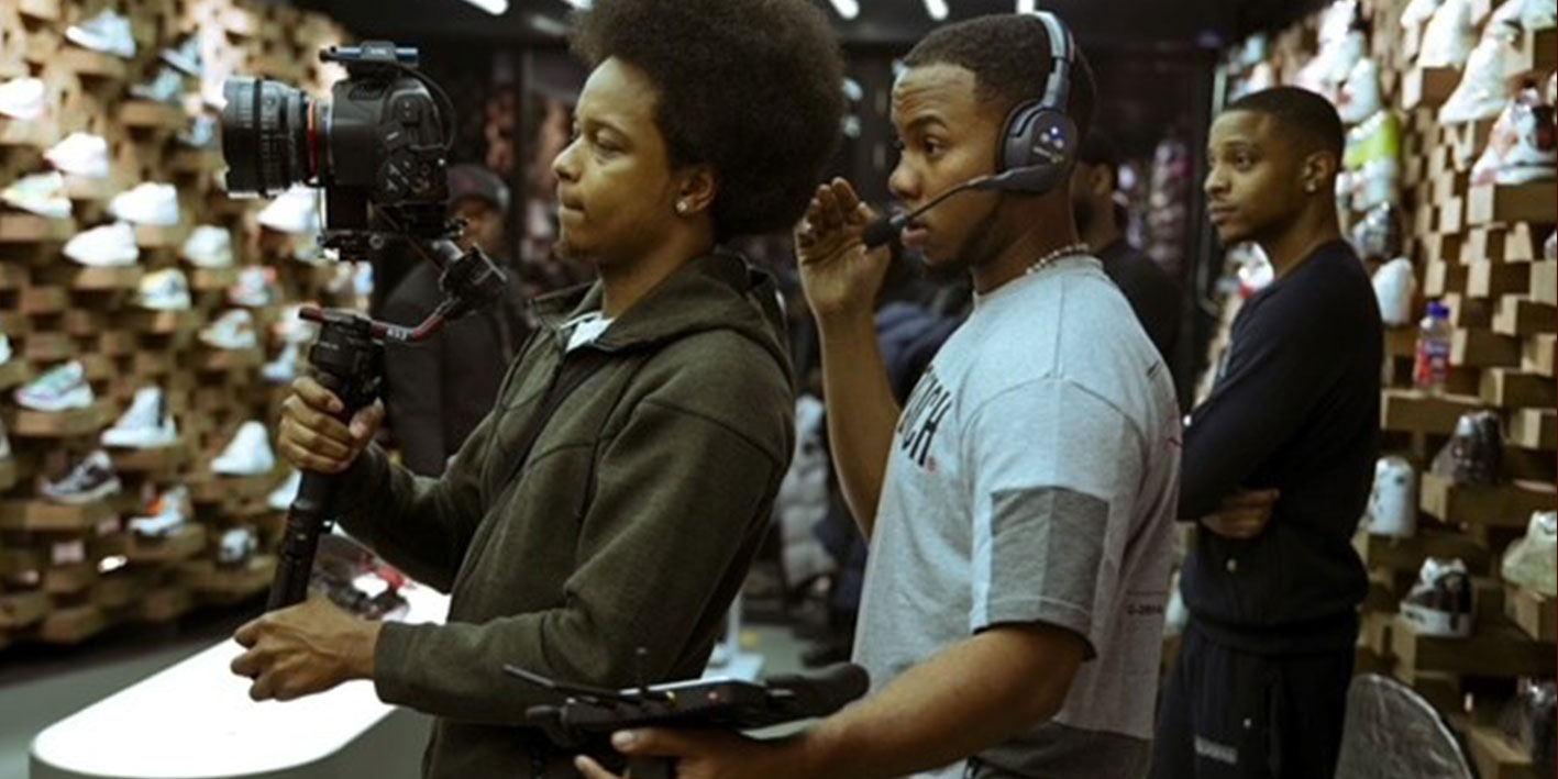 Alumni Theo Johnson shown working on a film set as he directs