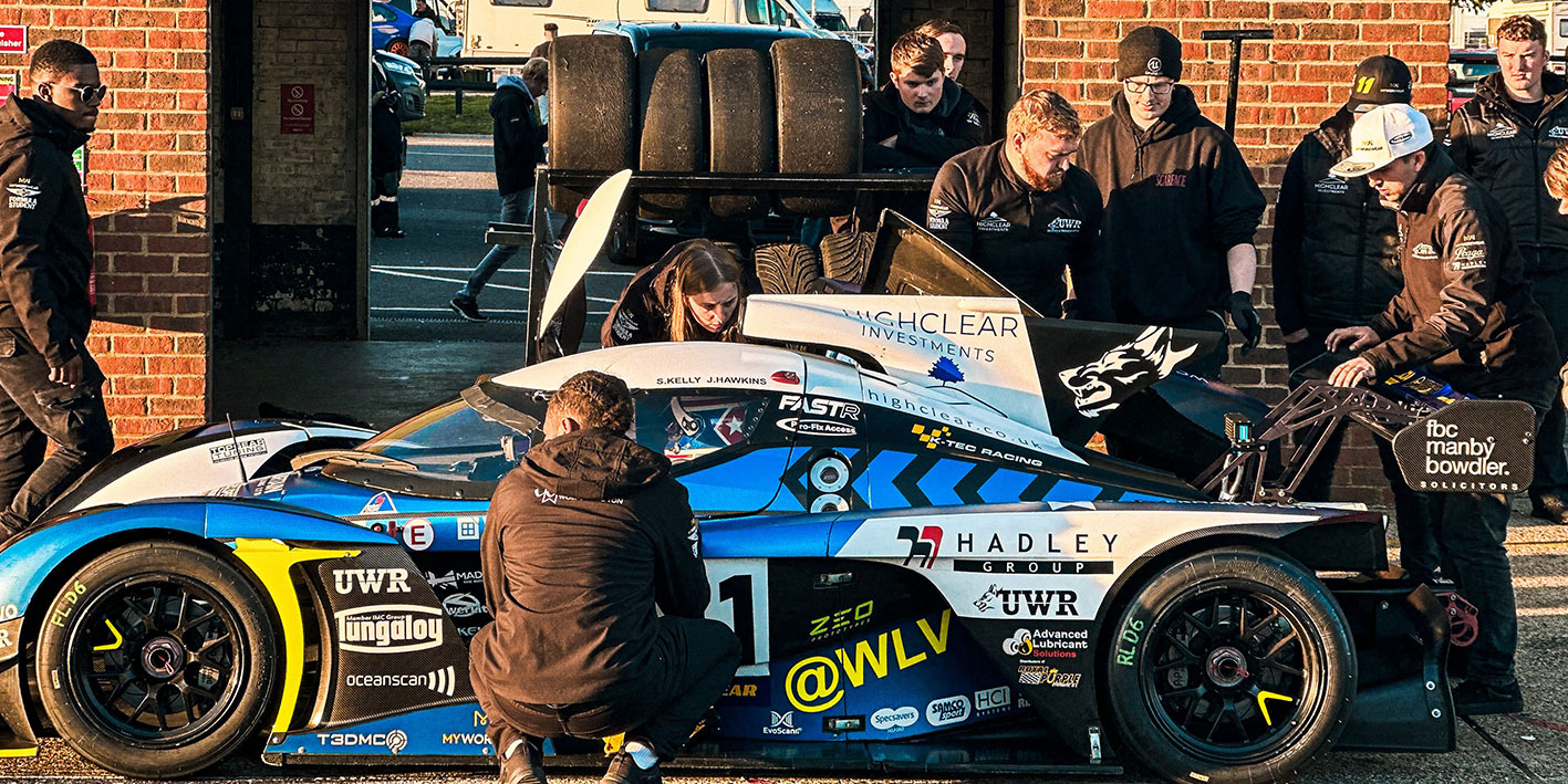 Motorsport racing team UWR working trackside on a Praga car