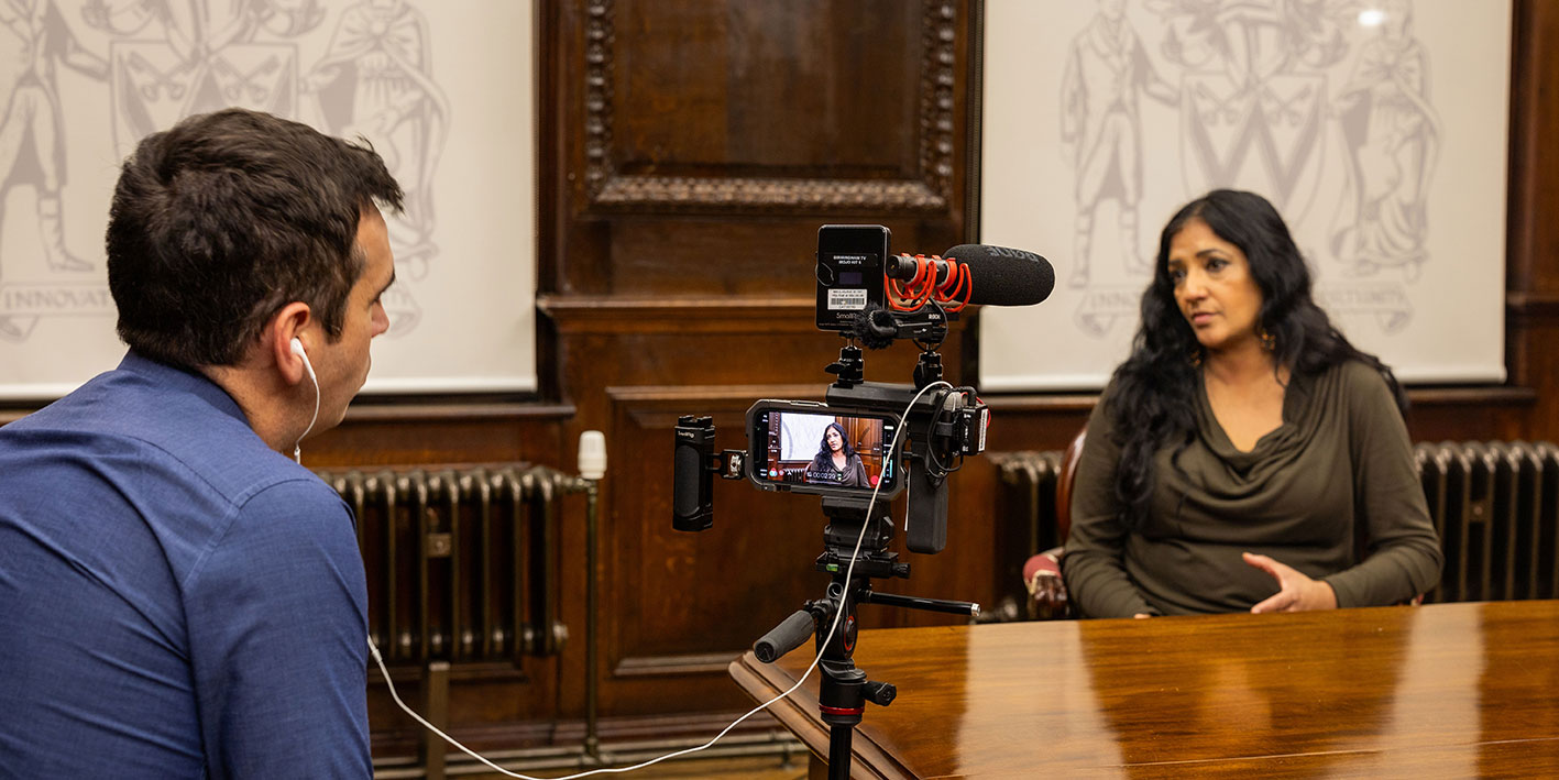 Research academic Opinderjit Takhar being filmed by BBC Midlands Today
