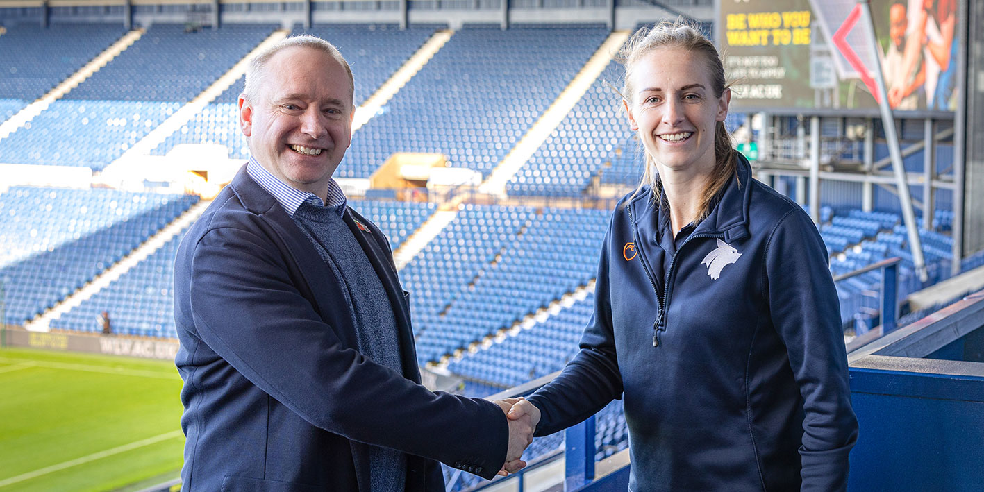 Kerys Harop shakes hands with the MD of WBA Football Club