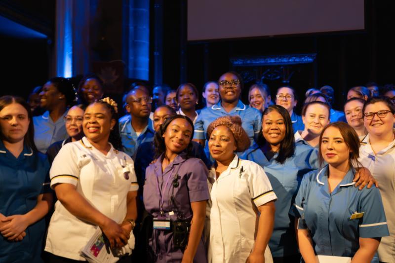 A group of nurses celebrating at their badge ceremony