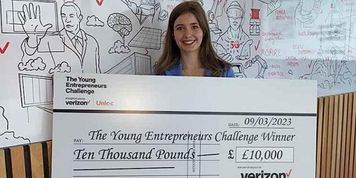 Women entrepreneurs Masterclass event. Photo of guest speaker Olivia Simpson holding large cheque