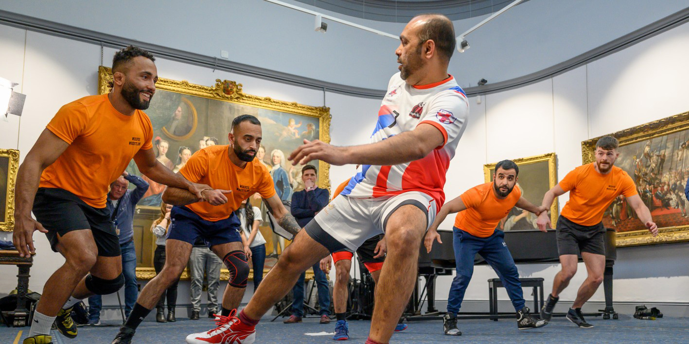Teaser for writing on the British Kabaddi League, showing sports players in uniforms indoors