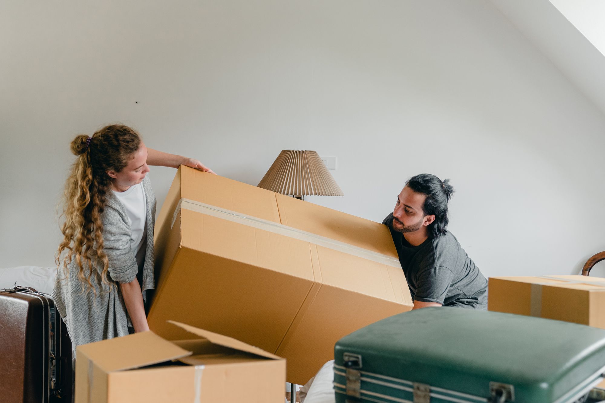 two students moving a large box