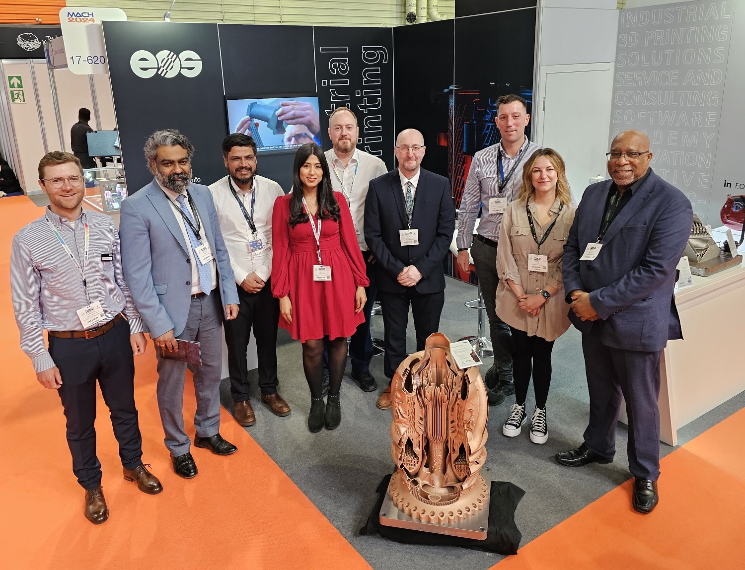 A group of University academics standing with a manufactured piece