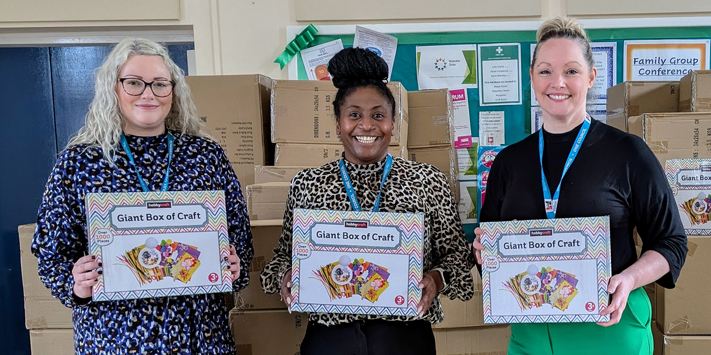 Three women holding up Lets Craft packs at Dudley Hub - Arts Connect programme