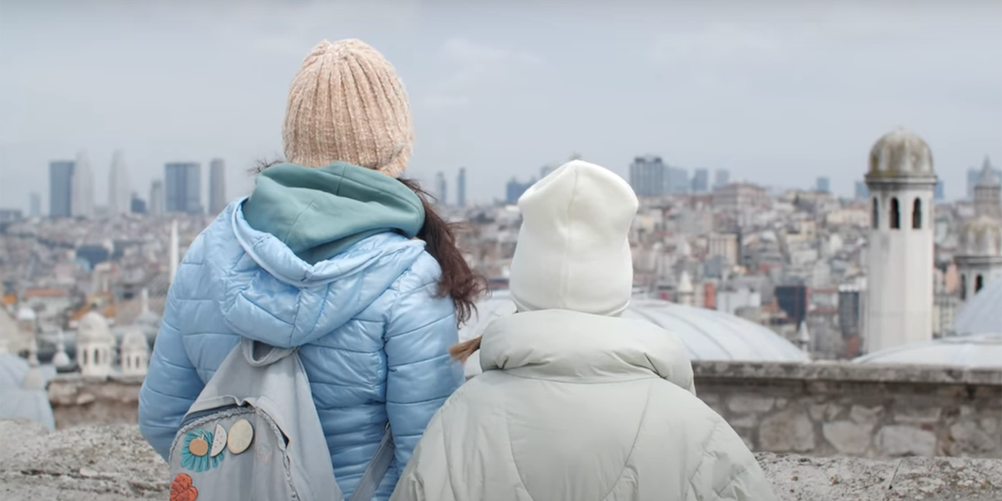two women looking out at earthquake devastated landscape