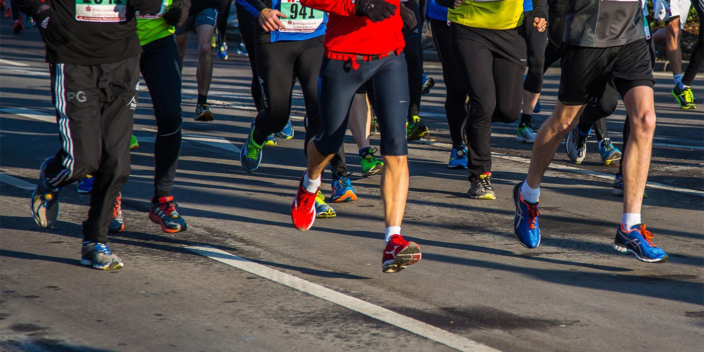 a photo of the legs of a group of marathon runners