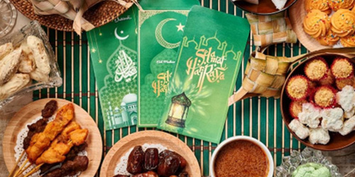a table full of food and a display of pamphlets in celebration of Eid ul Adha