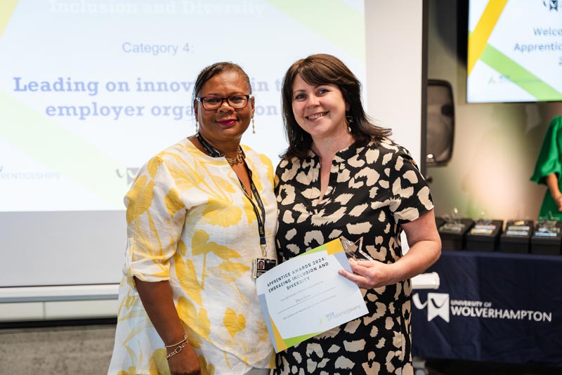 An apprentice receiving her award for studying for a Master's Leadership degree apprenticeship