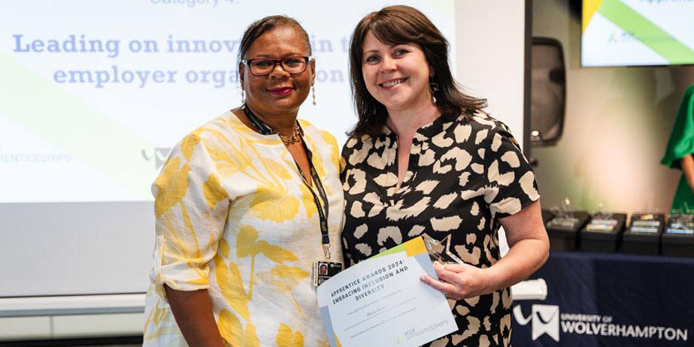 An apprentice receiving her award for studying for a Master's Leadership degree apprenticeship