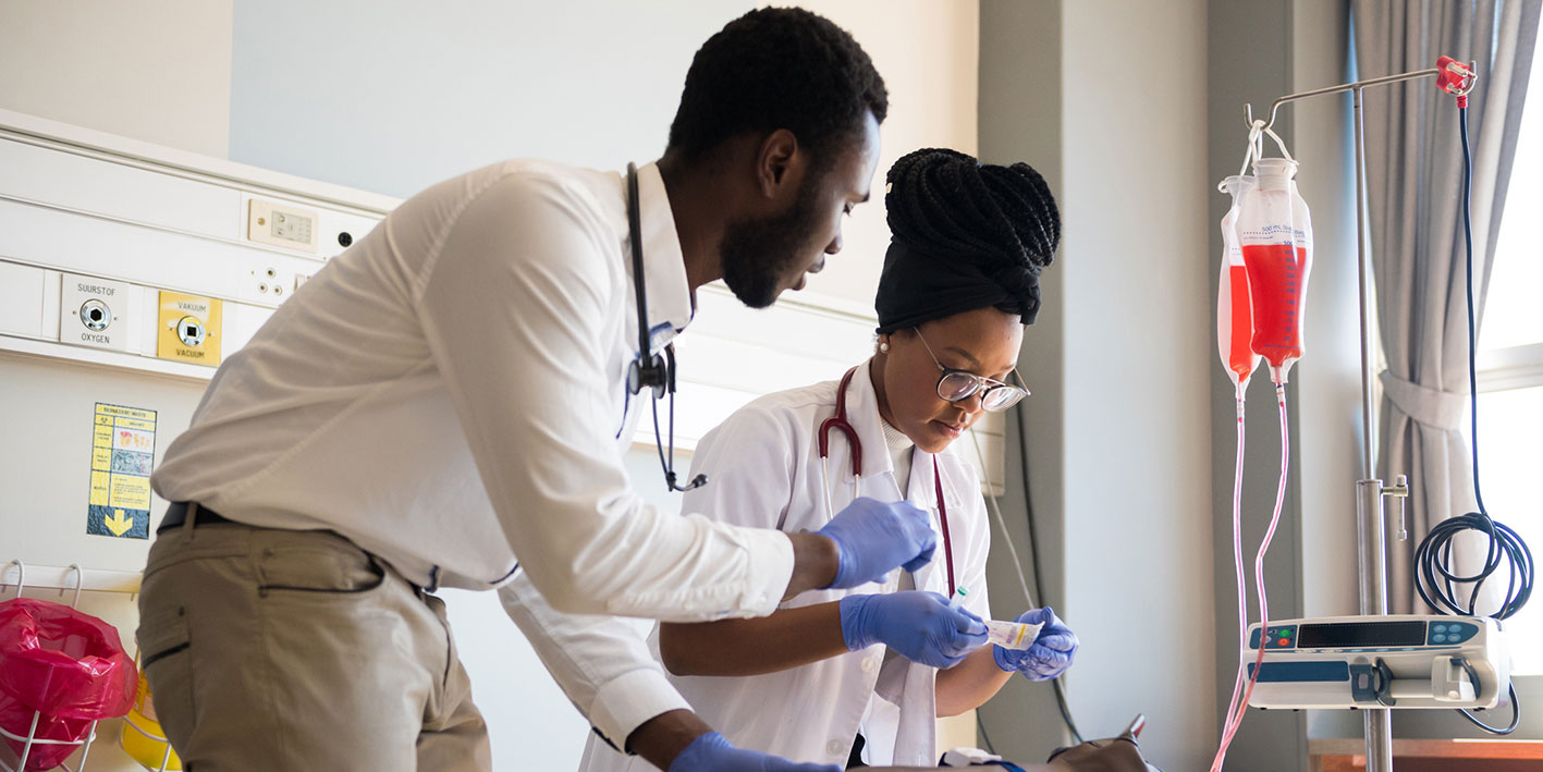 Two medical practice students at work
