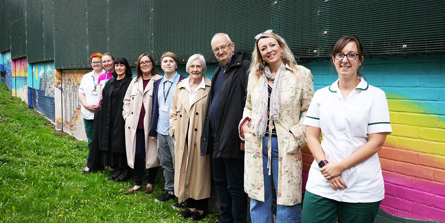 line up of staff and artists involved in the Arts for Health garden mural project at St Georges Hospital Staffordshire