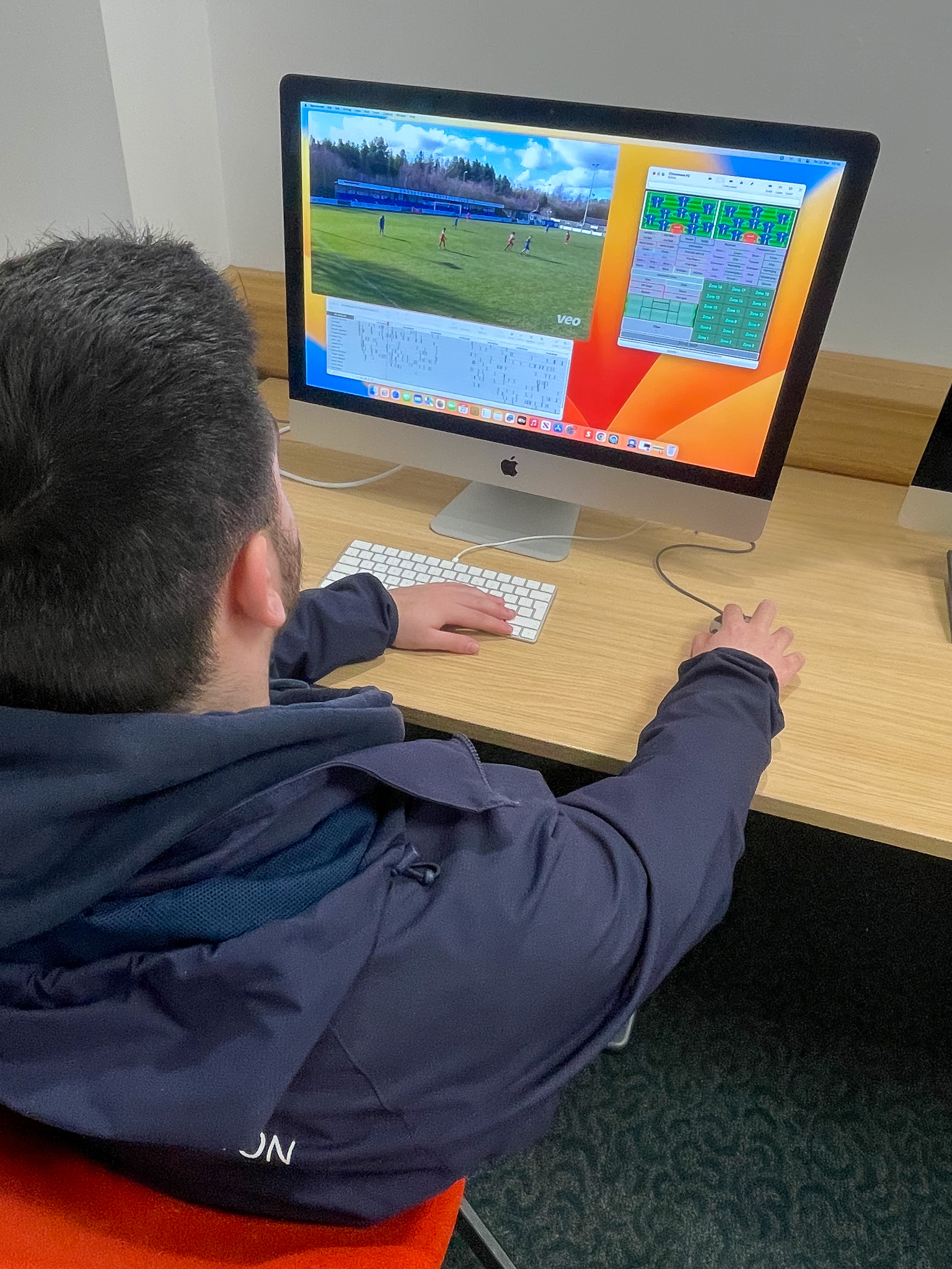A sports student back of the head using the Hudl performance analysis software on his computer screen