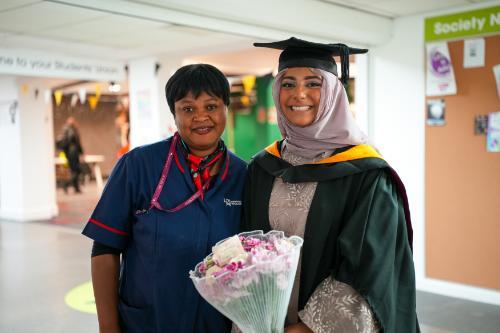 Student Zainab Sheikh poses with a University member of staff