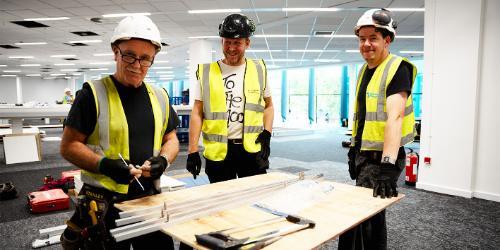 A group of Overbury workmen in Harrison Library working on the refurbishment