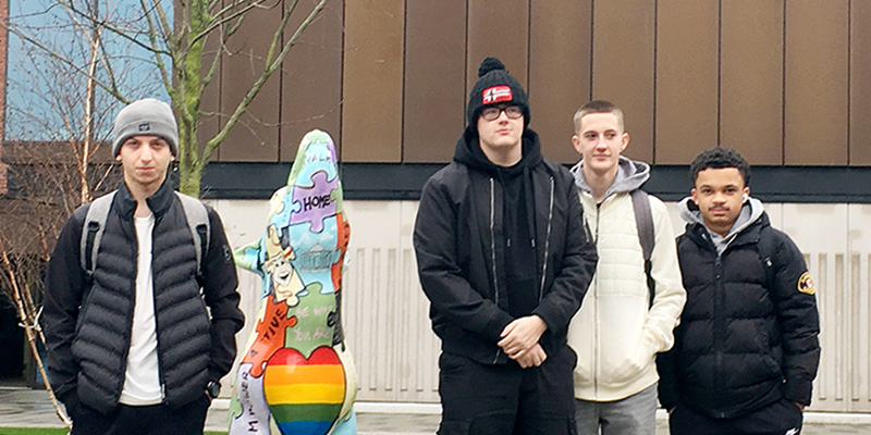 Three sports students in University courtyard