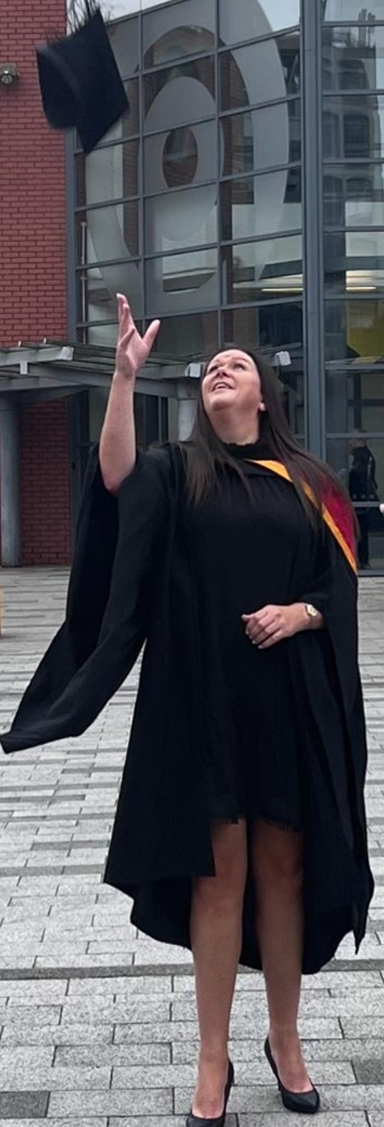 Early Childhood Studies graduate Suzanne Fisher throwing cap in air graduation photo