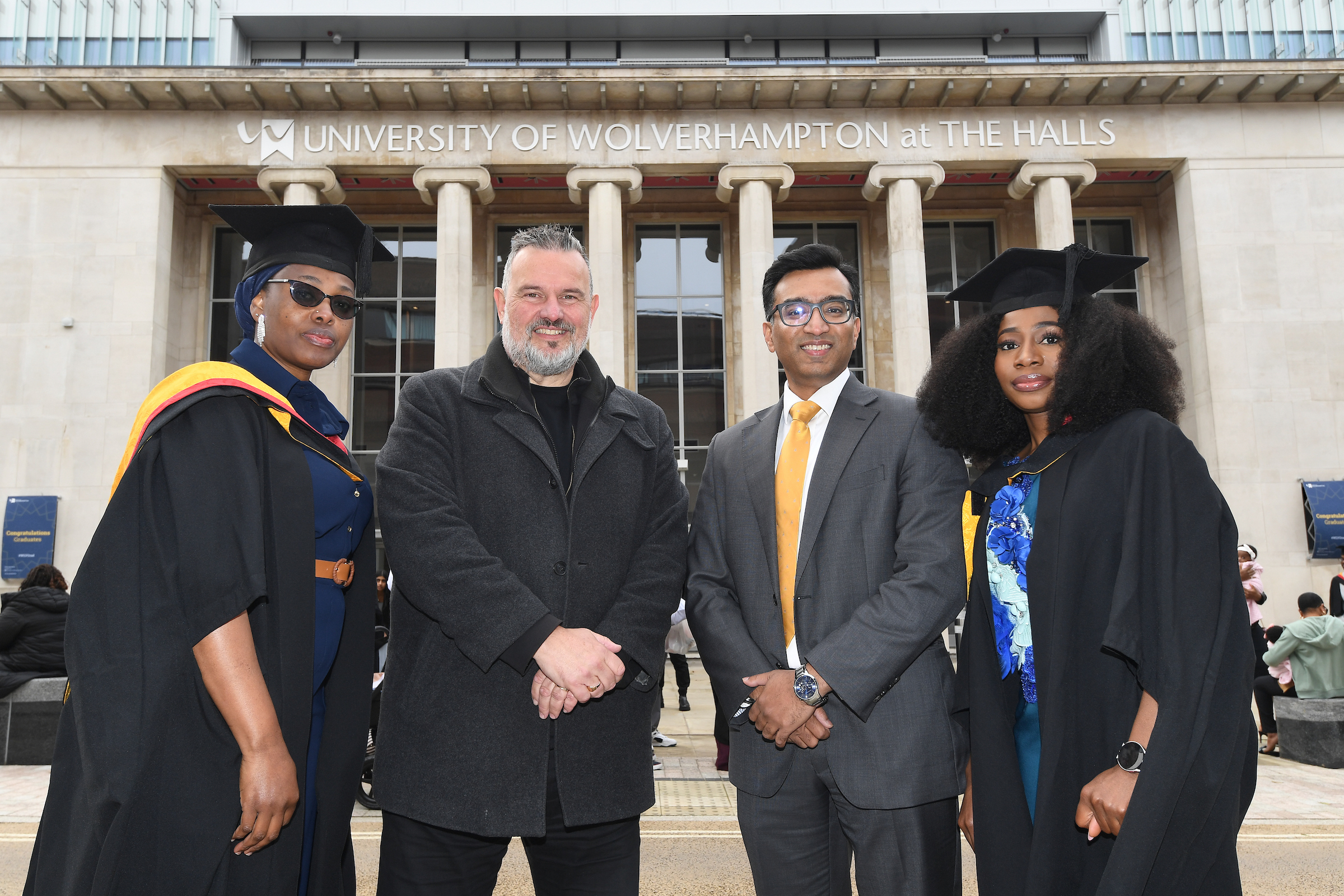 CEO of AEG and Pro Vice Chancellor Prashant Pillai outside The Halls with two graduates