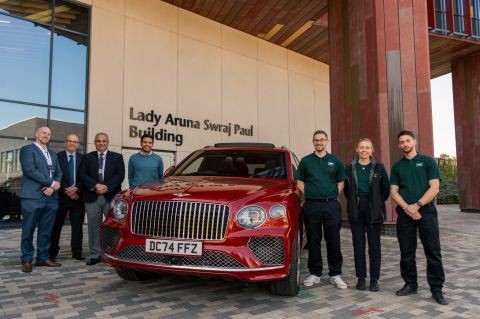 A group of people standing by a car