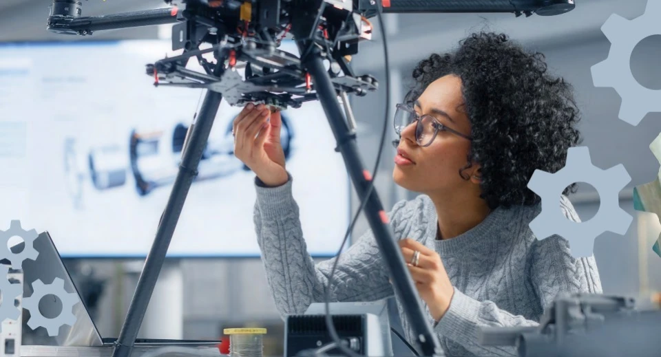 A female engineer works on a drone in a lab