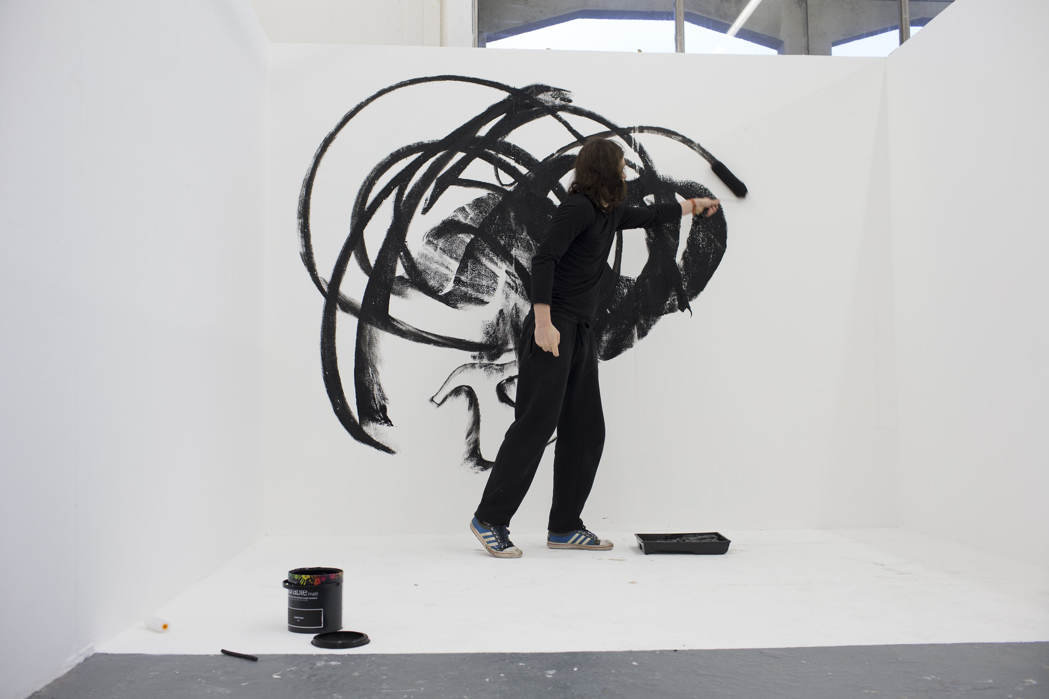 A person painting on a big canvas