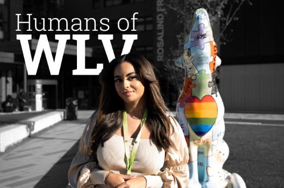 Angel Morphew on a black and white background of the courtyard at City Campus, a wolf statue in full colour behind her with white text reading Humans of WLV