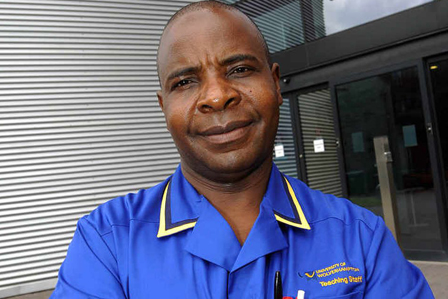 Profile photo of Dr Moses Murandu in University of Wolverhampton Nursing Teaching Staff uniform, standing outside in front of a building