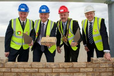Dean of the Faculty of Social Sciences at the University of Wolverhampton Miceal Barden, Vice-Chancellor Professor Geoff Layer, Mayor of Wolverhampton Councillor Ian Brookfield and Simon Butler, Interserve Divisional Director lay the top brick of the new Lord Swraj Paul Building. 