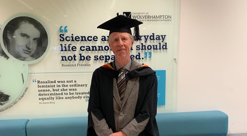 Michael Admiral pictured in robes at University of Wolverhampton