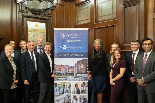 Representation from the University of Wolverhampton and America University of the Caribbean School of Medicine with a pull up banner announcing the partnership