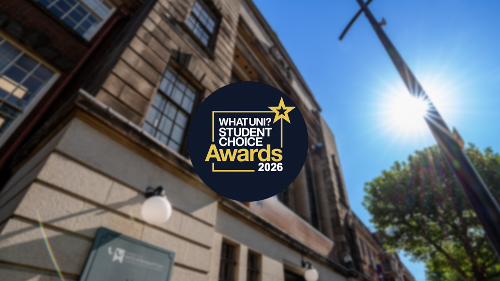 A picture of the outside of Wulfruna House, looking skyward. The WhatUni Awards 2026 emblem is in the centre on dark blue disk with white and gold writing
