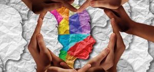 Header image crop of the cover for Childhood Wellbeing and Resilience with a drawing of a person's head between hands forming a heart shape