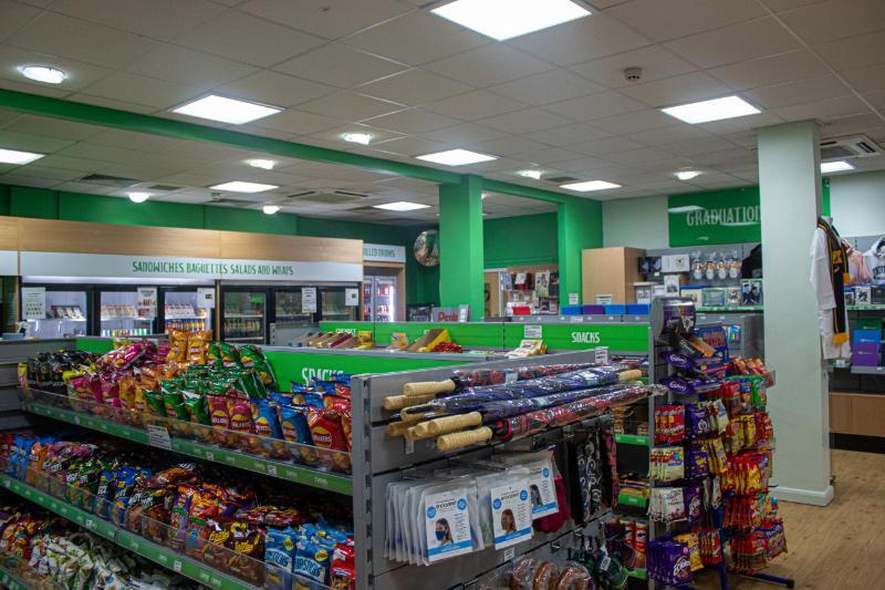 Shop in the MD building with snack aisles, sandwich fridges and graduation branded items