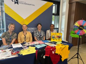 the business school stand with staff at open day