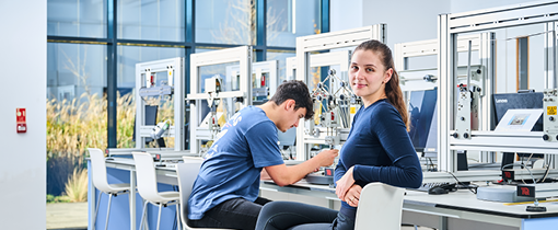 2 students sat in civil engineering lab testing the strength of their structures.