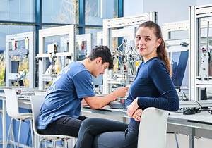 2 students sat in civil engineering lab testing the strength of their structures.