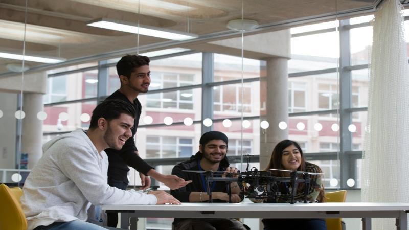 Students testing a drone in the classroom