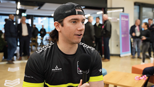 Student wearing race team top being interviewed about experiences on the course.