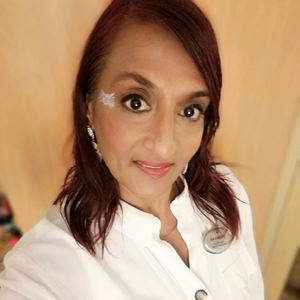 Selfie photo of student in white shirt and brown hair.