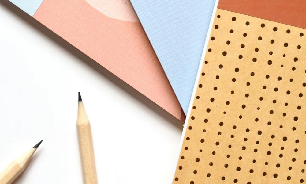 Two pencils and several pads of paper