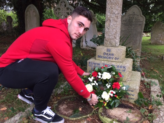 Jordan Moore-Taylor laying a wreath on grave of Edwin Clark