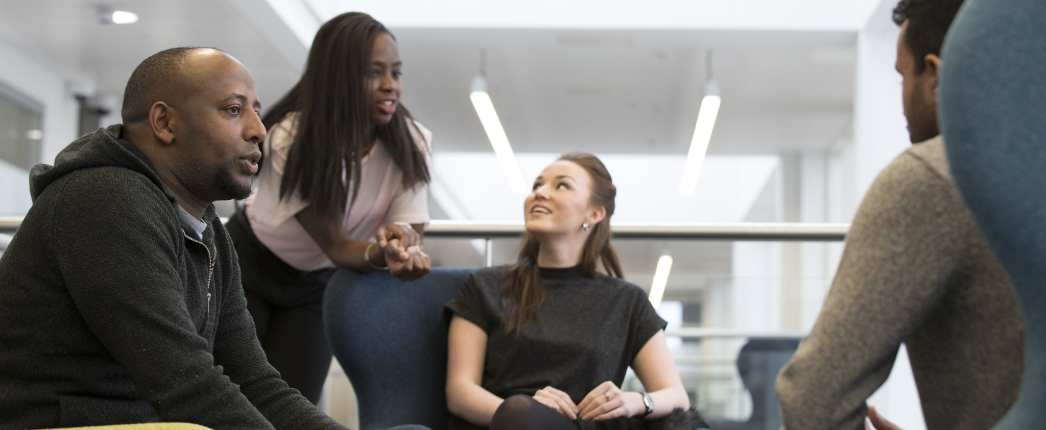 image of small group of students chatting in a social setting