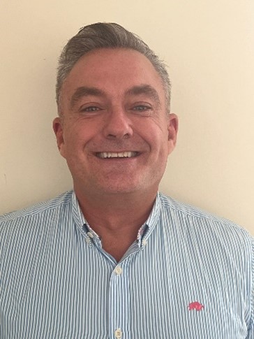 Paul Bytheway, independent governor 2024, photographed in a striped shirt against a white wall.
