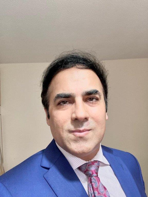 Fayaz Malik, co-opted governor, photographed wearing a tie and a blue suit.